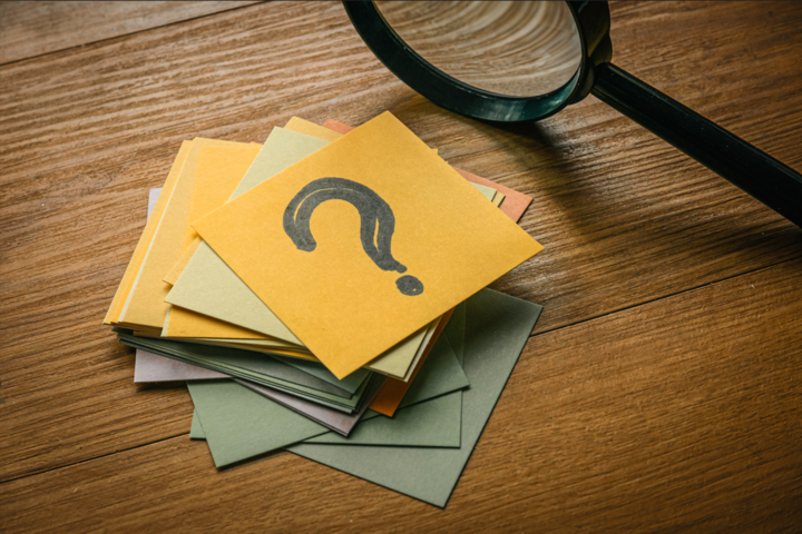 Questions and answers concept. how to create an faq section, A stack of paper with a paper on top written with question symbol tog